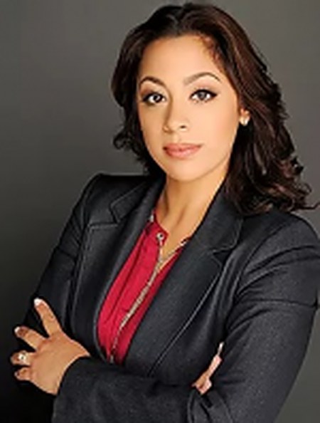 Attorney Annalie Alvarez, arms crossed, in a dark suit